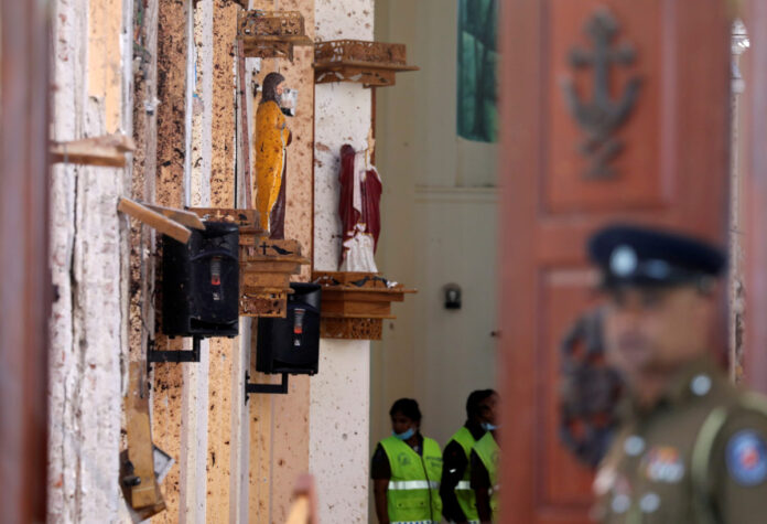 Police officers work at the scene at St. Sebastian Catholic Church in Negombo